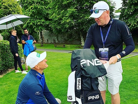 Adrian Meronk and caddy just checking out their golf bag.