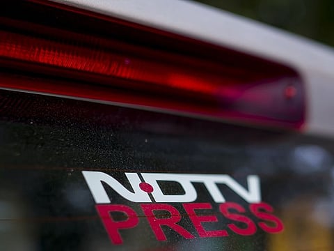 Signage of the New Delhi Television Ltd. (NDTV) on a car parked inside a parking compound in New Delhi.