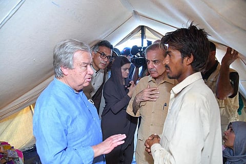 Pakistan's Primer Minister Shehbaz Sharif and United Nations Secretary-General Antonio Guterres (left) meeting internally displaced people at a makeshift camp during their visit to flood-affected Usta Muhammad city in Jaffarabad district in Balochistan province.