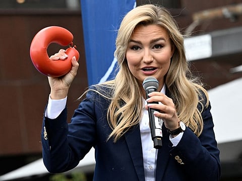 Ebba Busch, party leader of the Christian Democrats, holds a falukorv, a Swedish sausage, as she gives a campaign speech ahead of the general election, in Stockholm, on September 10, 2022.