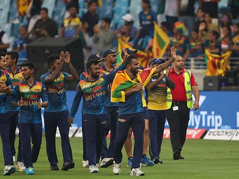 Sri Lanka's players celebrate their victory at the end of the Asia Cup Twenty20 international cricket final against Pakistan at the Dubai International Cricket Stadium in Dubai.