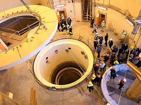 In this photo released by the Atomic Energy Organisation of Iran, technicians work at the Arak heavy water reactor's secondary circuit, as officials and media visit the site, near Arak, Iran, Dec. 23, 2019.