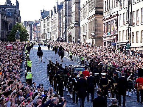 The Procession of Queen Elizabeth's coffin from the Palace of Holyroodhouse to St Giles Cathedral moves along the Royal Mile in Edinburgh, Scotland, Monday, Sept. 12, 2022.