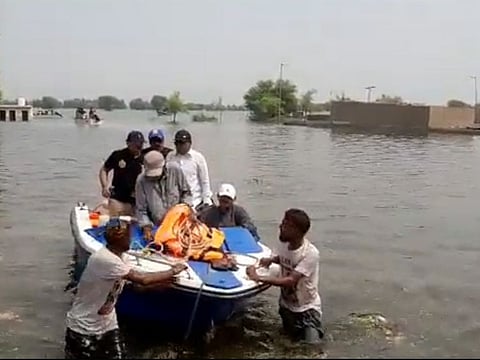 Shah's boat being towed by people of the nearby village.