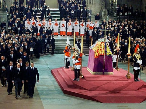 Britain's Prime Minister Tony Blair, front right, leader of the Liberal Democrats Charles Kennedy, front second right, Iain Duncan-Smith, the leader of the Conservative Party and Deputy Prime Minister John Prescott, front left, file past officers from the Household Cavalry standing in vigil at the coffin of Britain's Queen Elizabeth the Queen Mother as it lies in state in Westminster Hall in London Friday, April 5, 2002.
