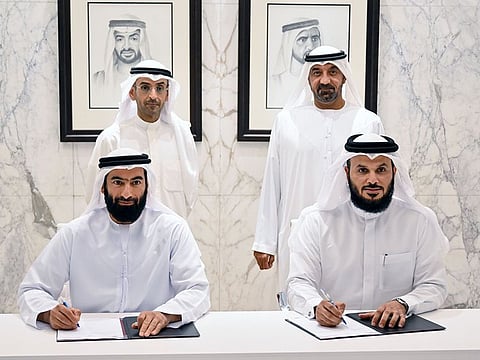Sheikh Ahmed bin Saeed Al Maktoum (standing right) and Dr Nayef Falah M. Al Hajraf (standing left) witnessed the signing of the MoU