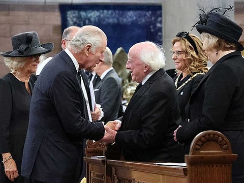 Britain's King Charles III greets President Michael D Higgins during a Service of Reflection for the life of Queen Elizabeth II at St Anne's Cathedral in Belfast on September 13, 2022, during his visit to Northern Ireland.