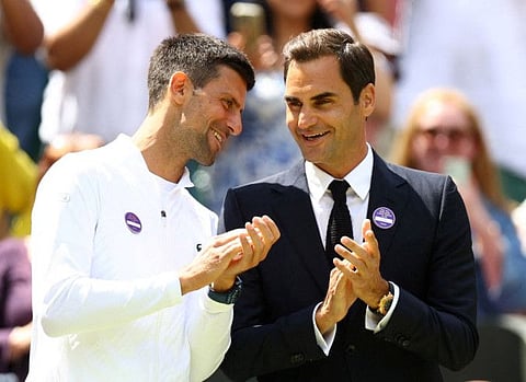 Serbia's Novak Djokovic and Roger Federer having a laugh during the Wimbledon centre court centenary celebrations at All England Lawn Tennis and Croquet Club in July.