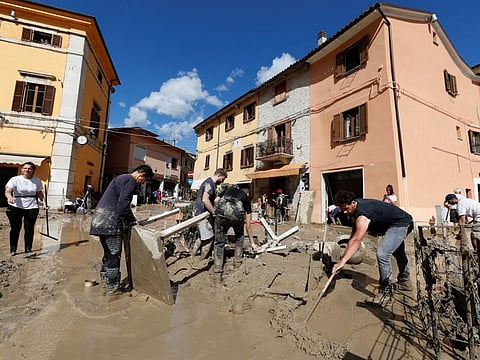 People work to clear way after heavy rain and deadly floods hit the central Italian region of Marche, in Cantiano, on September 16, 2022.