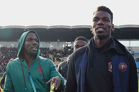 Mathias Pogba (left) the elder brother of the footballer Paul Pogba, and three other people have been placed in custody.