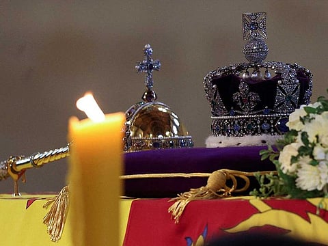 The coffin of Queen Elizabeth II, draped in the Royal Standard and adorned with the Imperial State Crown and the Sovereign's orb and sceptre, is pictured Lying in State inside Westminster Hall, at the Palace of Westminster in London on September 18, 2022.