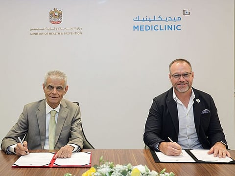 Khalil Ibrahim Qayed (left), director of NCHR, and David Hadley, CEO of Mediclinic Middle East, sign the agreement
