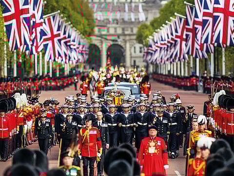 The Queen’s coffin is pulled past Buckingham Palace following her funeral service in Westminster Abbey in central London.