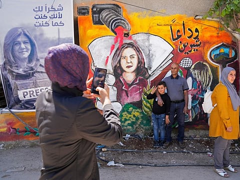 Palestinians visit the site where veteran Palestinian-American Al Jazeera reporter Shireen Abu Akleh was shot and killed, in the West Bank city of Jenin, May 18, 2022.