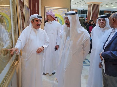Mohammed Al Murr, Chairman of Mohammed bin Rashid Al Maktoum Library Foundation, seen while calligrapher Hakim Ghannam talks about his work during the inauguration of a grand art exhibition under the title of 'Al Owais Symposium on Arabic Calligraphy' at the Sultan Bin Ali Al Owais Cultural Foundation in Dubai on Monday
