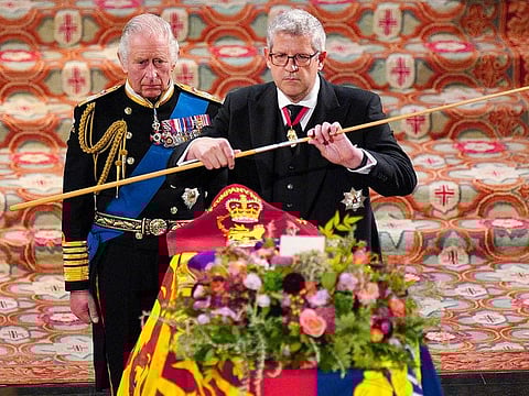 King Charles III (L) watches as the Lord Chamberlain breaks his Wand of Office at the Committal Service for Queen Elizabeth II held at St George's Chapel in Windsor Castle on September 19, 2022.