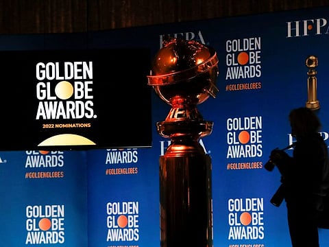 A person holds a camera next to the Golden Globe statue before the 79th Annual Golden Globe Awards nominations announcement in Beverly Hills, California, US, December 13, 2021.