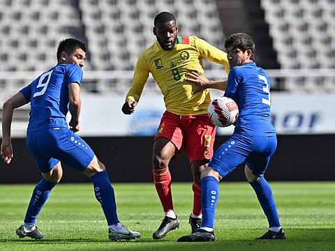 Cameroon's Olivier Ntcham (centre) fights for the ball with Uzbekistan's Odil Khamrobekov (left) and Khojiakbar Alijonov during a friendly in Goyang on Friday.