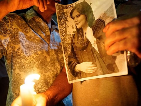 A image of Mahsa Amini at a candlelit vigil following her death in Los Angeles, California on September 22, 2022. The Iranian government cut most internet access for its 80 million citizens during a crackdown on demonstrators protesting the death of Amini in the custody of Iran’s morality police.