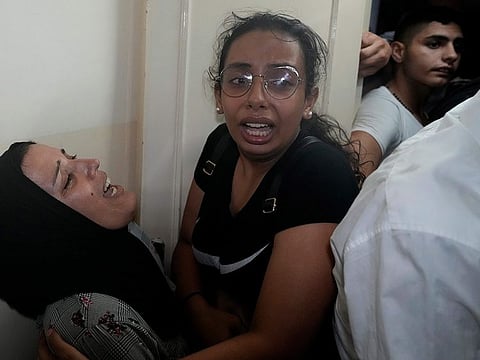 Relatives of two victims who were on a boat carrying migrants from Lebanon that sank in Syrian waters, mourn at their house after they bring back home their bodies, in Tripoli, north Lebanon, September 23, 2022.