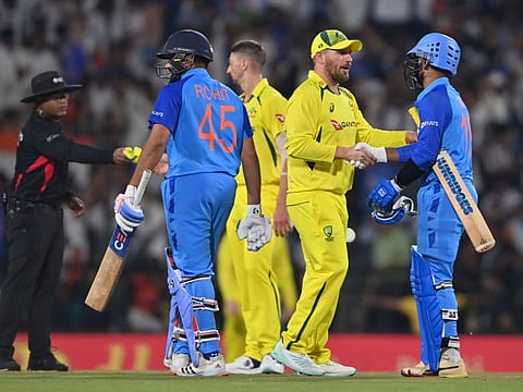 Australia's captain Aaron Finch (centre) congratulates India's wicketkeeper Dinesh Karthik (right) at the end of the second Twenty20 international match at the Vidarbha Cricket Association stadium in Nagpur. There will be all to play for in tomorrow's series decider.