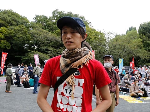 Mayumi Ishida, one of the protesters, speaks to media at a park during a protest against holding the state funeral for the former Prime Minister Shinzo Abe, in Tokyo on September 23, 2022.