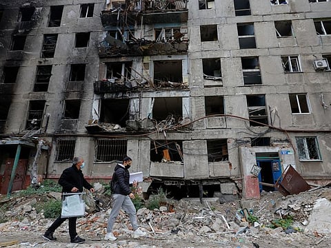 Members of an electoral commission with a mobile ballot box and documents while visiting local residents on the second day of a referendum on the joining of the self-proclaimed Donetsk People's Republic (DPR) to Russia, in Mariupol, on September 24, 2022.