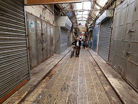 A man walks past closed shops during a strike following an Israeli raid in Nablus, in the West Bank, September 25, 2022.