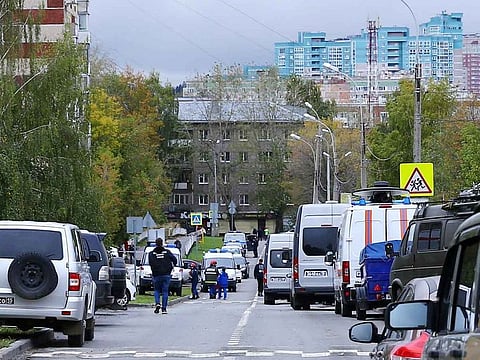 Police and members of emergency services work near the scene of a school shooting in Izhevsk, Russia September 26, 2022.