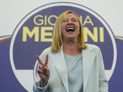 Far-Right party Brothers of Italy's leader Giorgia Meloni flashes the victory sign at her party's electoral headquarters in Rome, early Monday, Sept. 26, 2022.