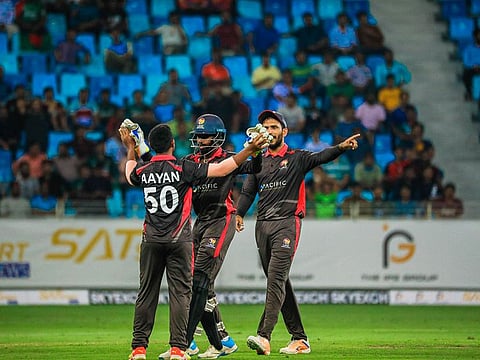 UAE skipper CP Rizwan (right), who scored an unbeaten 51, celebrates a wicket with young left-arm spinner Aayan Khan and Vriitya Aravind.