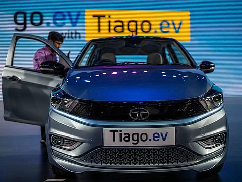 A journalist takes picture of Tata Tiago EV electric car during its global launch in Mumbai, India, Wednesday, Sept. 28, 2022.