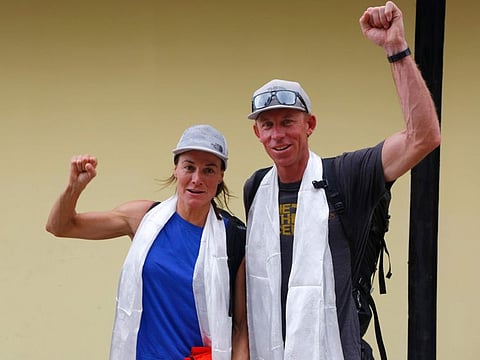 Hilaree Nelson of Telluride, Colorado, left and James Morrison of Tahoe, California, raise their fists as the pair arrived in Kathmandu, Nepal, Oct. 4, 2018.