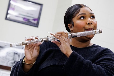 Lizzo plays a crystal flute at the Library of Congress.