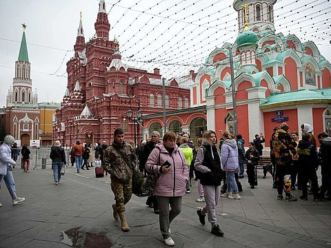 People walk in Nikolskaya street outside Red Square in central Moscow on September 28, 2022.