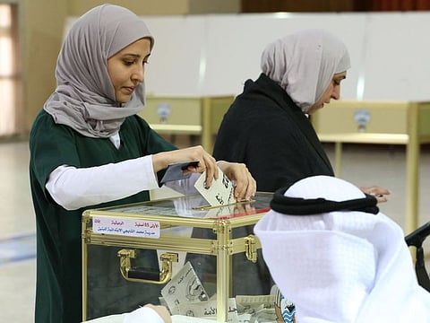 Kuwaiti women cast their votes during parliamentary elections in Kuwait City on September 29, 2022.