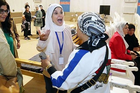 Kuwaiti candidate Jenan Bu Shehri celebrates with her supporters following the announcement of her victory in the parliamentary elections, in Kuwait city, early on September 30, 2022.