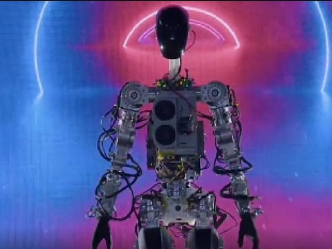 At Tesla's AI Day late Friday, Musk also showed a video of the robot picking up boxes and moving through a rendered office building to water plants.