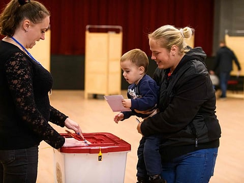 People vote at a polling station during the general election on October 1, 2022 in Riga, Latvia.