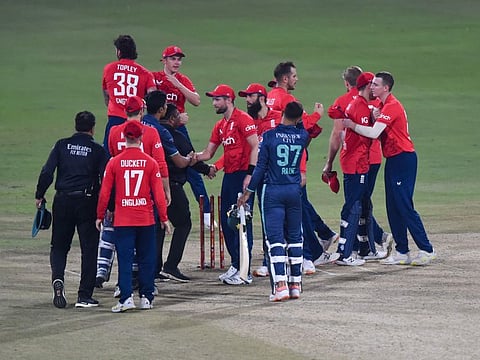 England's players celebrate their victory in the seventh Twenty20 international cricket match against Pakistan at the Gaddafi Cricket Stadium in Lahore.