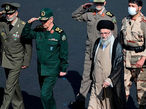 In this picture released by the official website of the office of the Iranian supreme leader, Supreme Leader Ayatollah Ali Khamenei, foreground right, reviews a group of armed forces cadets during their graduation ceremony accompanied by commanders of the armed forces, at the police academy in Tehran, Iran, Monday, Oct. 3, 2022.
