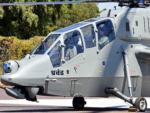 India's Defence Minister Rajnath Singh sits in a locally-made light combat helicopter 'Prachand' during its induction ceremony at the air base in Jodhpur on October 3, 2022.