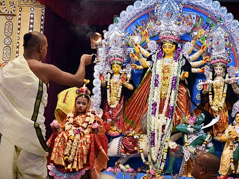 A priest performs Kunwari Kanya Puja on the occasion of Maha Ashtami of the Durga Puja festival celebrations, at Belur Math, in Kolkata on Monday, October 3, 2022.