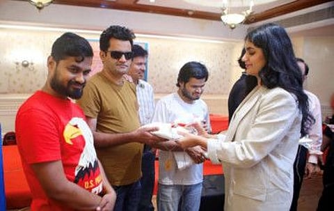 Namya Manghnani gifts the costumes that she stitched to the the visually impaired members of the Unique Sense music band in Mumbai.