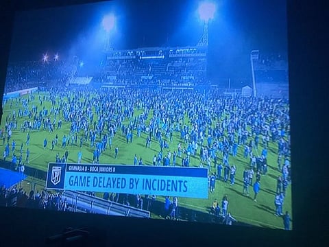 At least one person died Thursday when violent unrest near a Buenos Aires soccer match between Boca Juniors and Gimnasia y Esgrima spilled into the stadium and onto the pitch, authorities said.