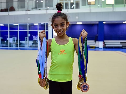 Lamia Al Farsi exhibiting the medals she has won so far during an interview with Gulf News recently.