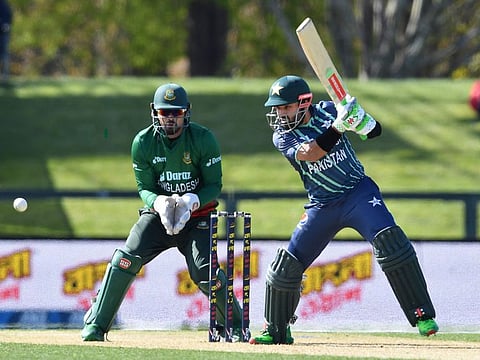 Pakistan's Mohammad Rizwan plays a backfoot drive shot as Bangladesh's wicketkeeper Nurul Hasan looks on during the first match of the tri-series at Hagley Oval in Christchurch on Friday.