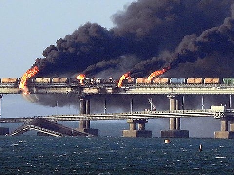 Smoke billows from a fire on the Kerch bridge that links Crimea to Russia, after a truck exploded, near Kerch, on October 8, 2022.