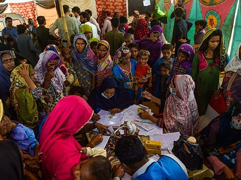 Internally displaced flood affected people gather at a medical camp set up for the flood affected in Jamshoro district of Sindh province.