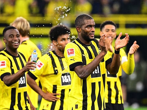 Borussia Dortmund's Anthony Modeste celebrates with teammates after the match.